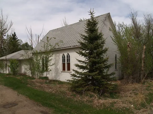 Old white wooden church with Gothic windows